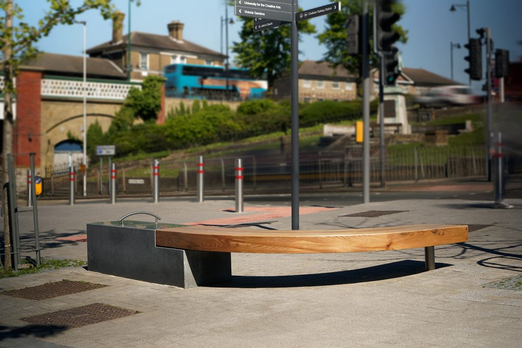 circular timber seat and granite bench cleaning to a road