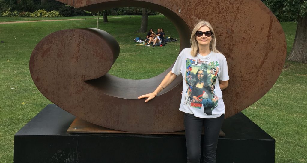 Laura in front of a large scale Corten steel number 5
